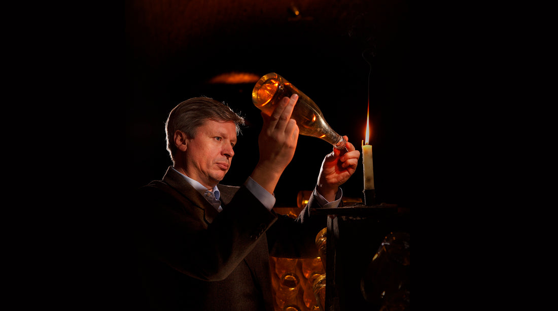 Jean-Baptiste Lécaillon inspects a bottle of Champagne