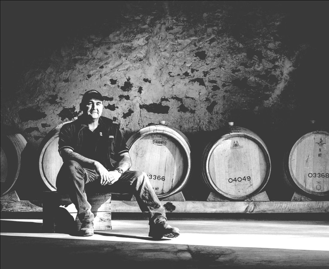 A winemaker in the barrel store