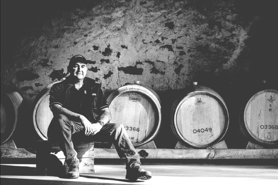 A winemaker in the barrel store