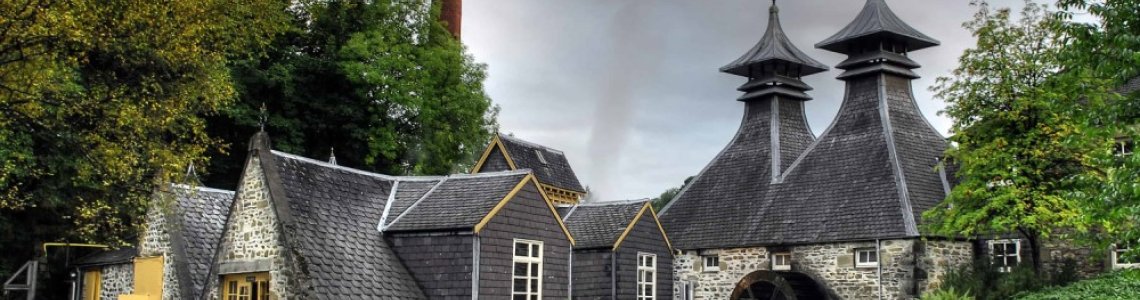 A Scottish distillery under a heavy sky